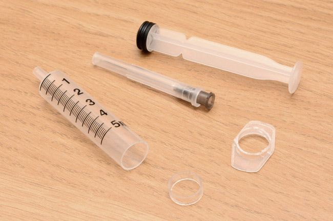 Syringe cut up to make plastic tube sections