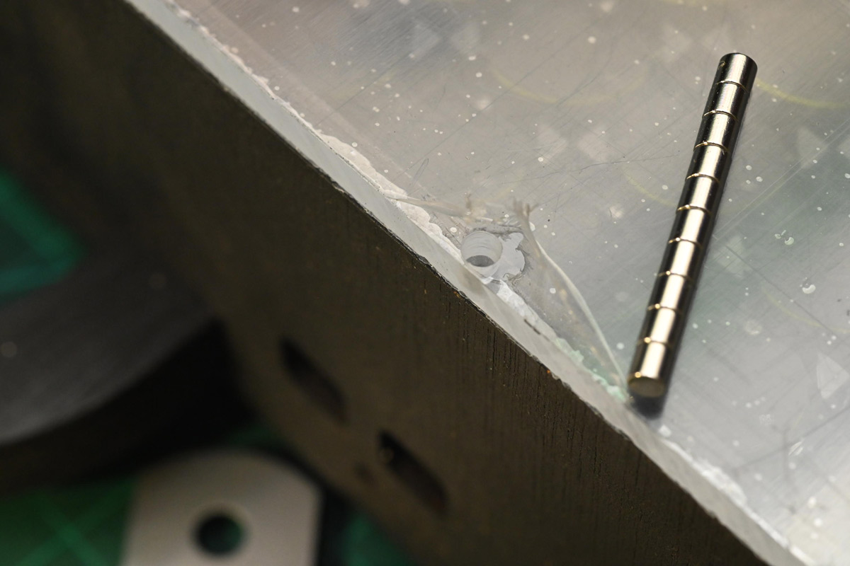 Magnets next to a hole in the acrylic cover