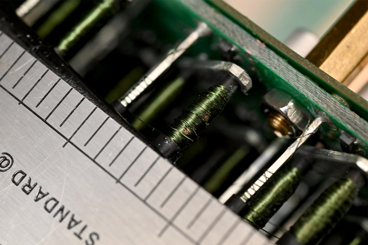 Closeup of a coil near a standoff with visible damage