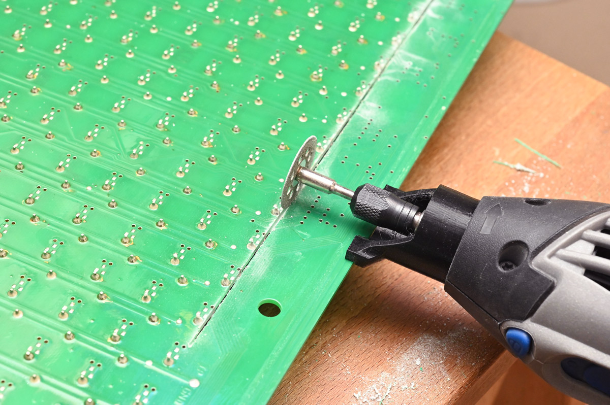 Using the dremel with 3d printed fence to cut off excess circuit board
