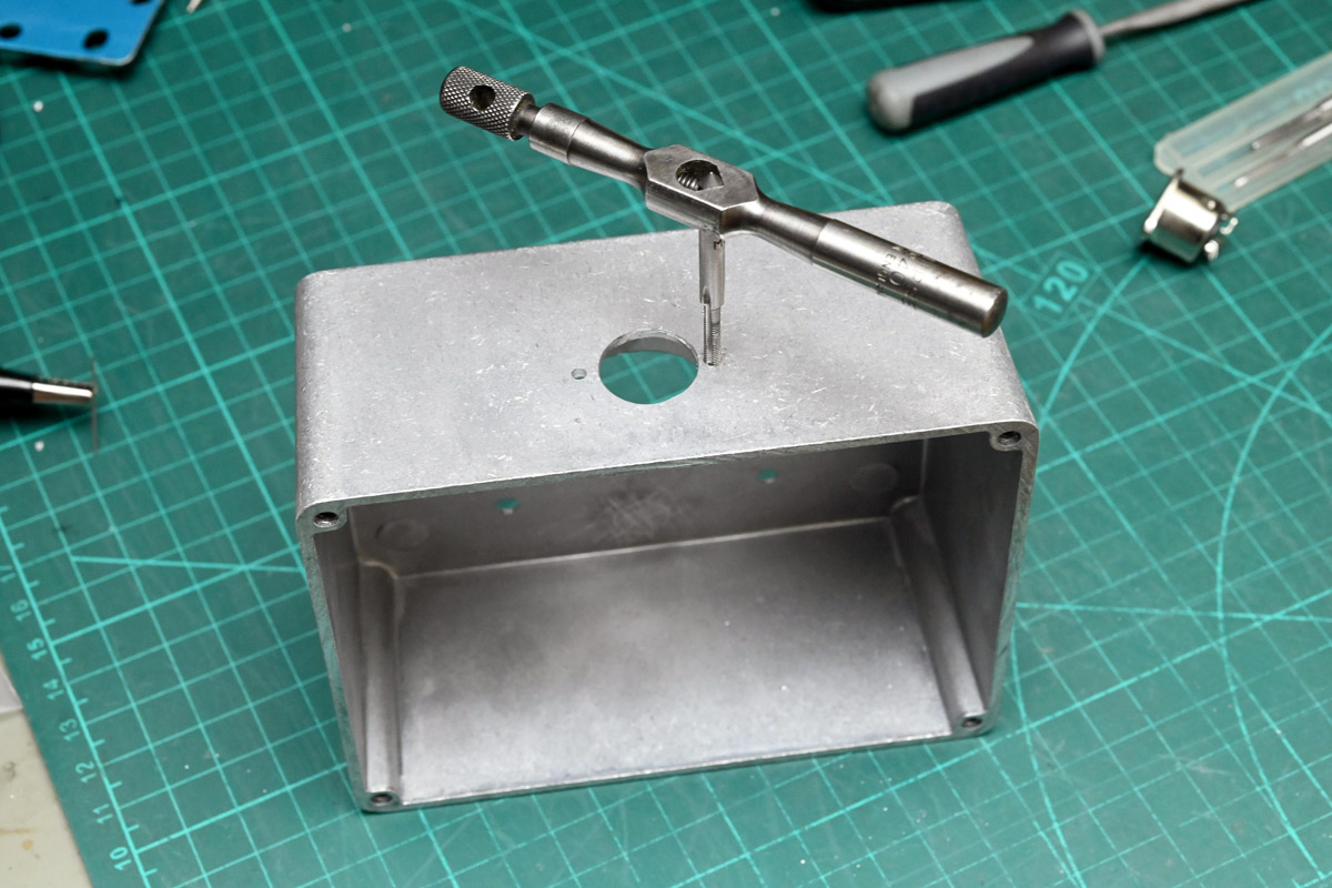 Tapping holes for the DIN connector