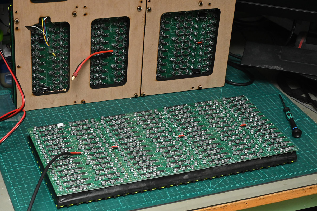 Another panel with driver boards fitted, with the original panel in the background
