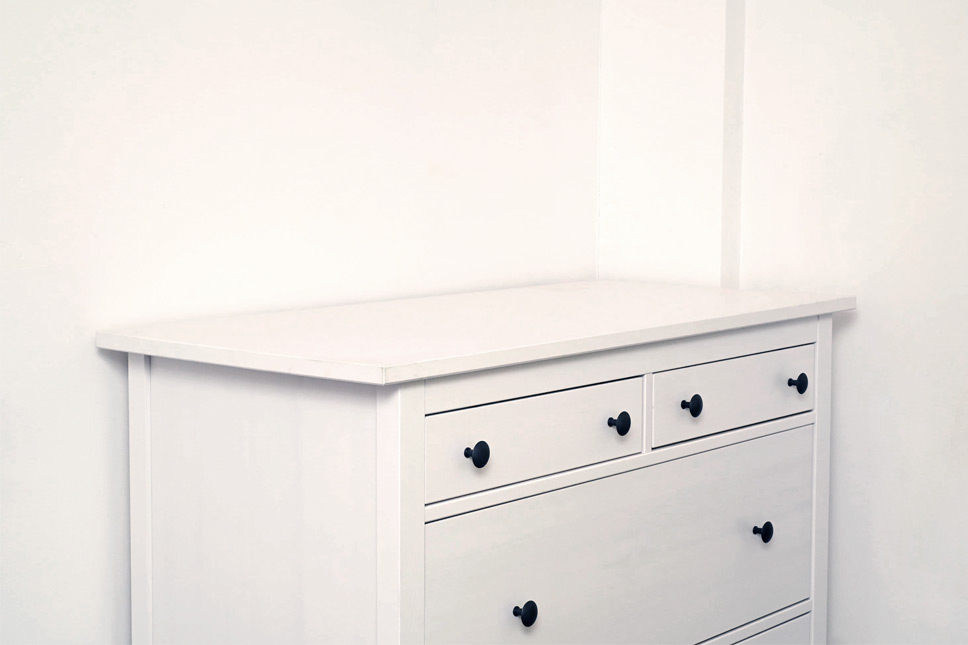 Dresser with conspicuously empty space above it