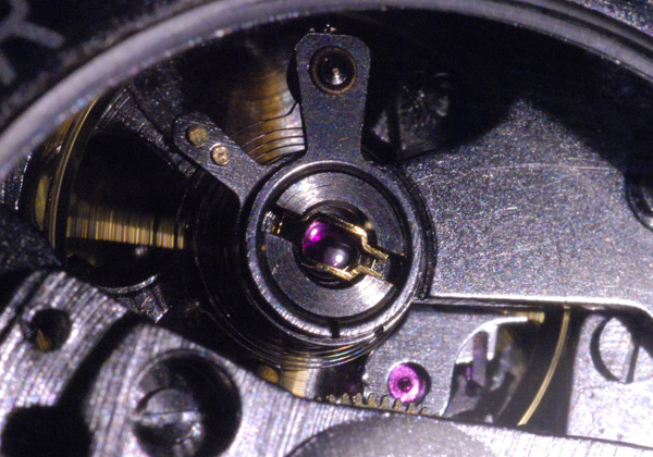 Macro picture of a jewelled balance wheel in a mechanical watch