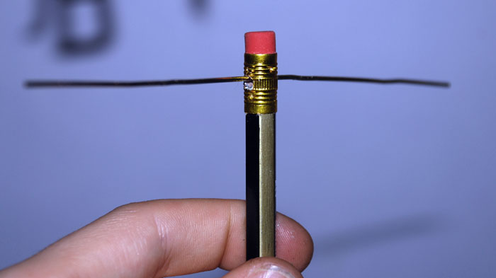 Pencil with paperclip wire threaded through