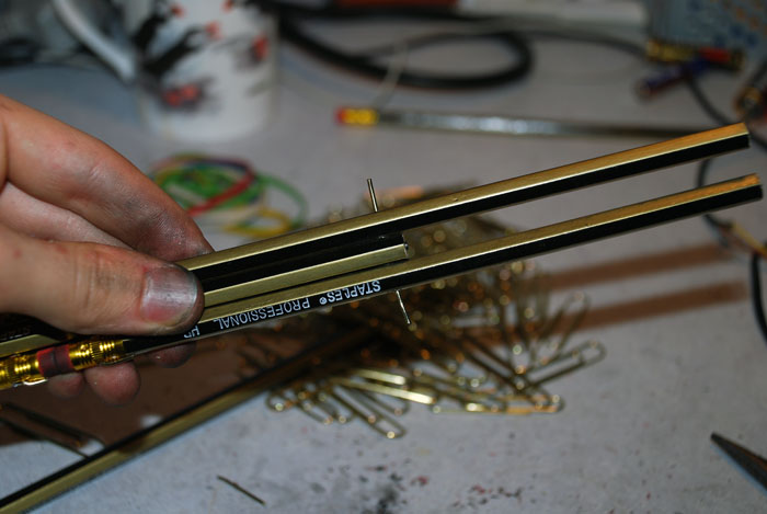 Pencils joined by threading wire through drilled holes