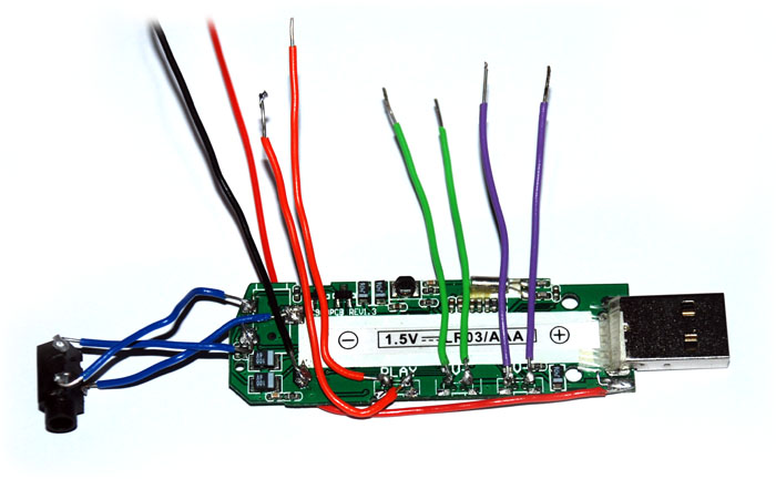 MP3 player circuit with wires soldered to main buttons and output port