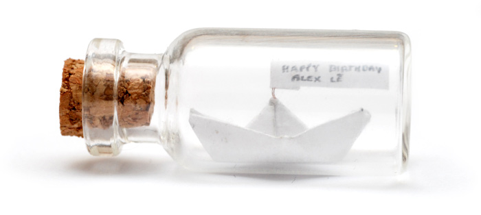 A very tiny paper ship in a bottle
