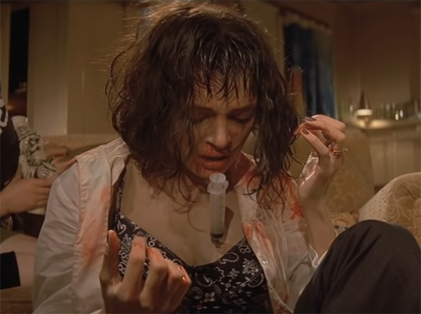 Uma Thurman with a syringe in her chest