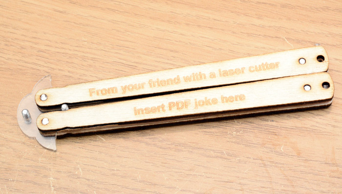 Laser-etched text on the side reads: From your friend with a laser cutter, insert PDF joke here