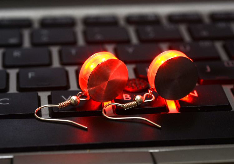 Closeup of the two finished earrings glowing