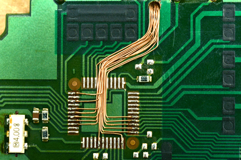Magnet wire carefully soldered to each of the pads of the original chip