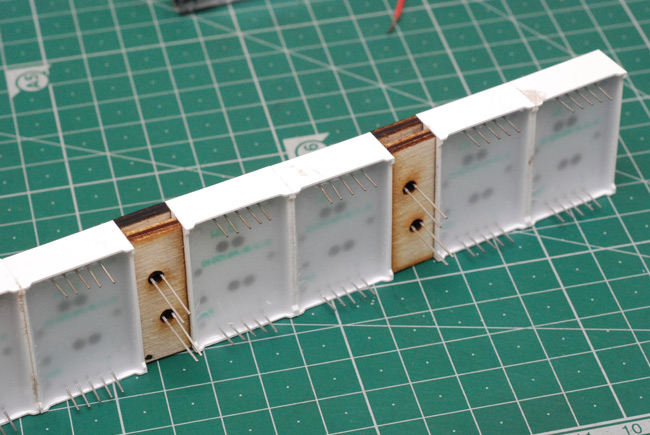 7-segment displays glued together with laser-cut colon LEDs