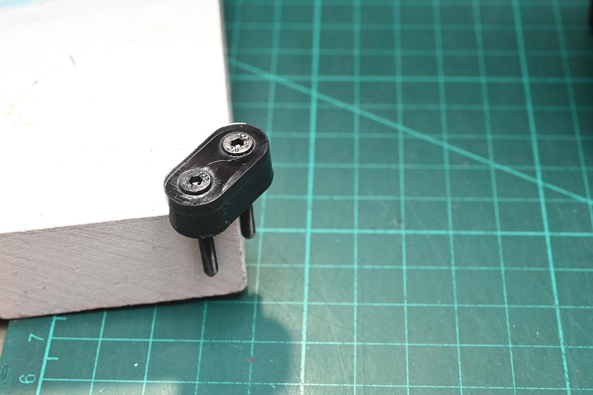 Hinge linkage with countersunk acrylic and bolts