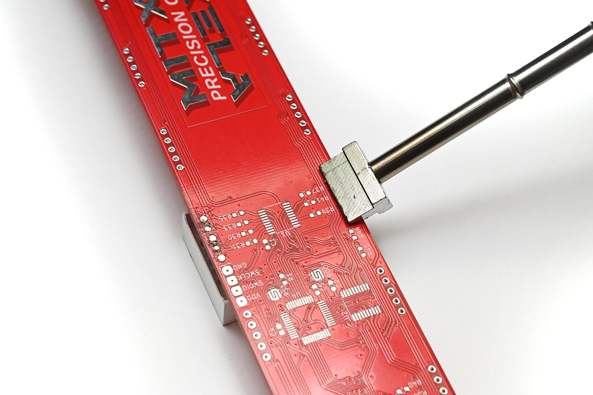 Spade bit face down on pins