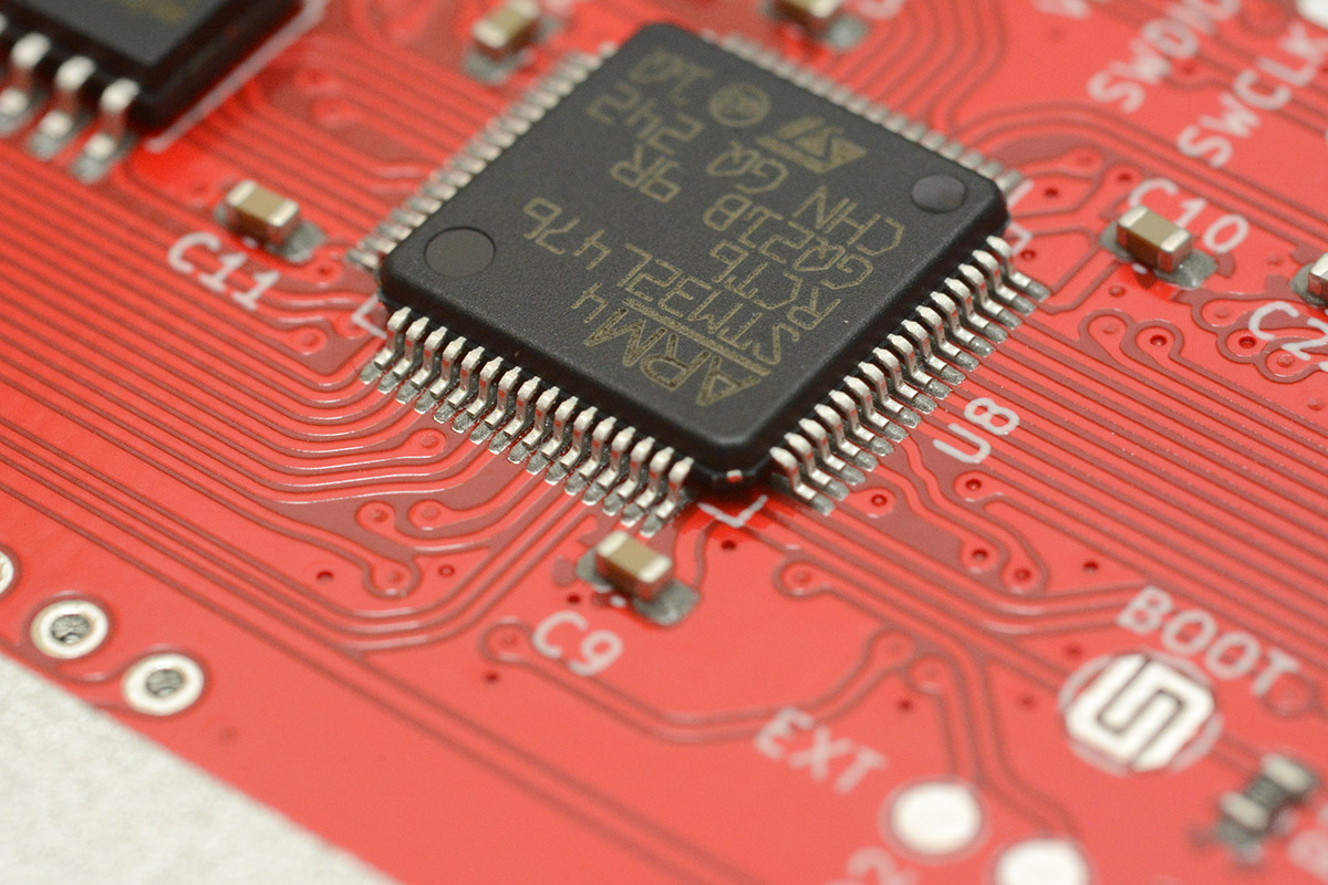 Parts placed on stencilled paste, closeup of microcontroller pins