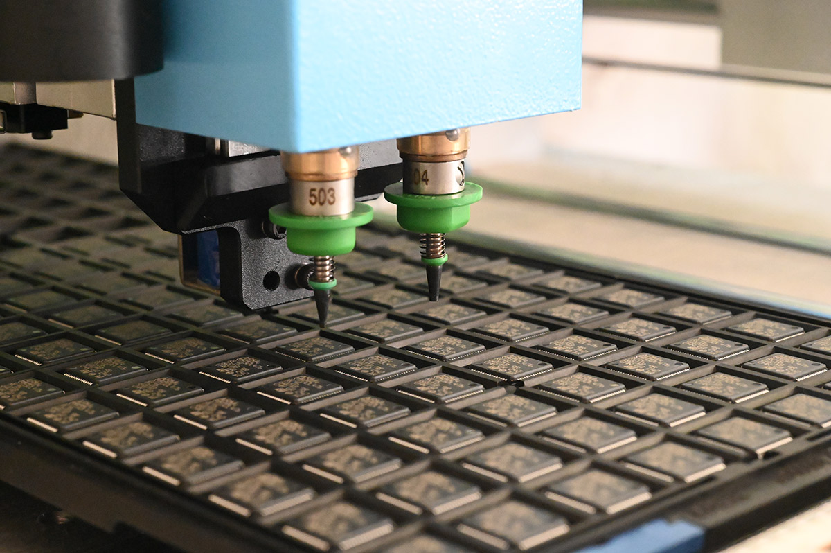 Closeup of pick and place heads over IC tray