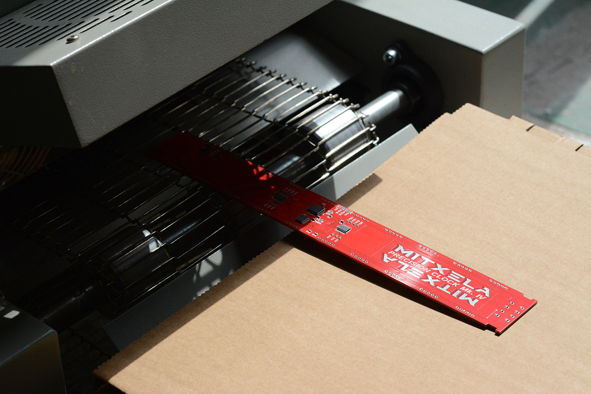 PCB with logo exits the reflow oven