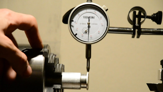 Dialing in the runout with the fourjaw chuck and test indicator