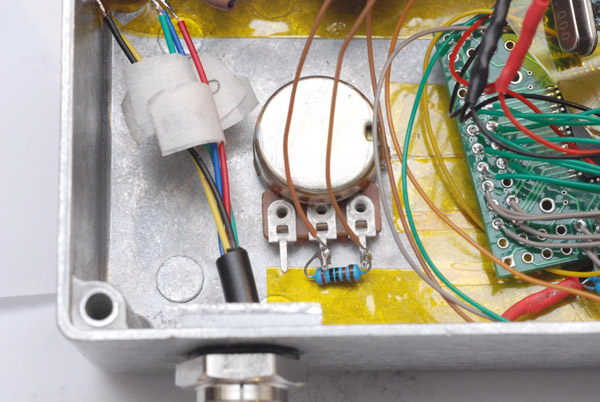 A resistor is fitted between two of the legs of the potentiometer