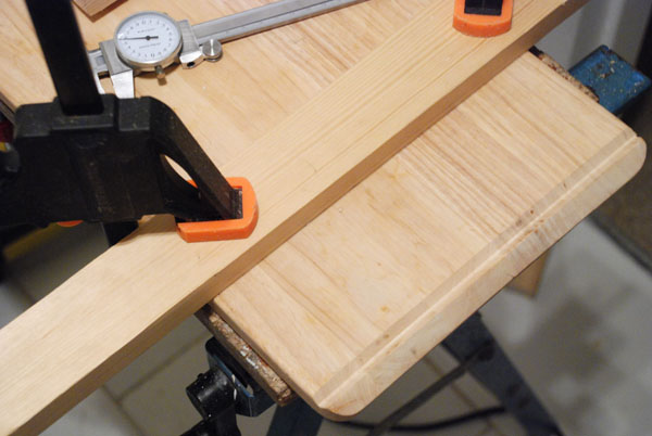 Wood clamped to form a guide for routing the draining board