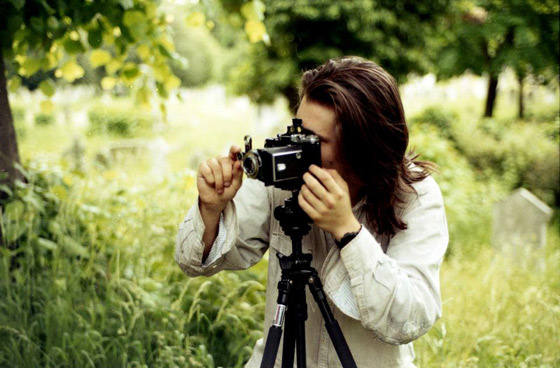 Photograph of the author operating a folding camera on a tripod