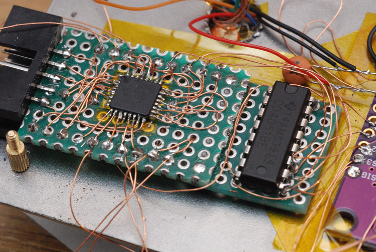 Protoboard with dense wiring mounted onto the back of the panel