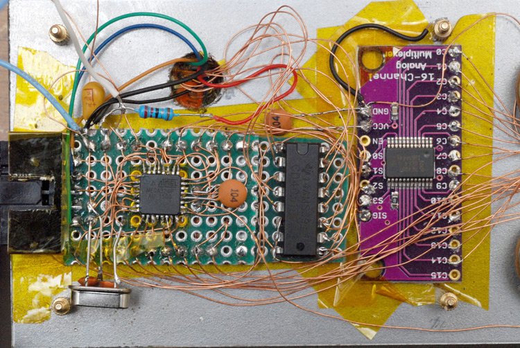 Top down view of the protoboard and multiplexer chips, with extra capacitors and a crystal