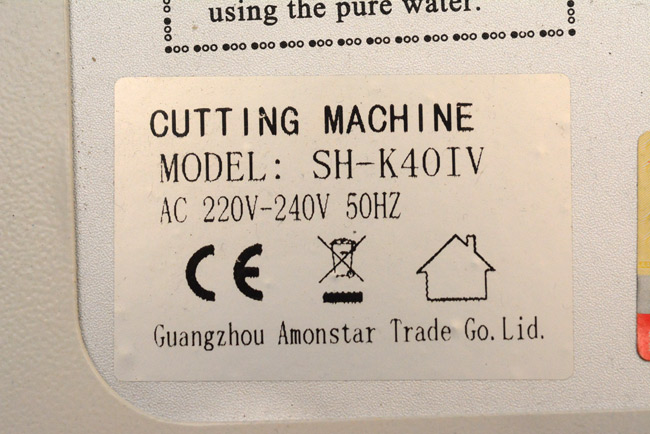 Label on the laser cutter, reads Cutting Machine Model SH-K40IV, Guangzhou Amonstar Trade Go. Lid.