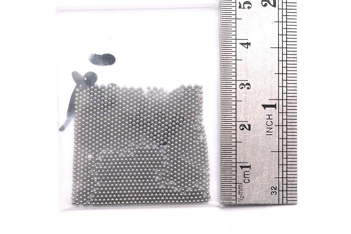 Bag of tiny ball bearings next to a ruler