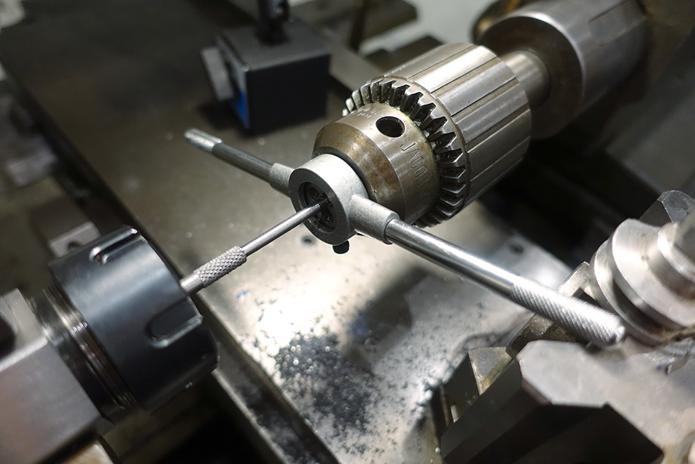 Threading the part using a die holder held with the tailstock chuck
