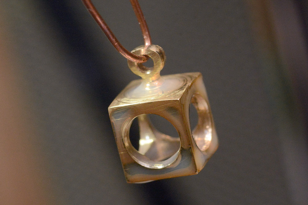A cube earring after dipping in varnish. 