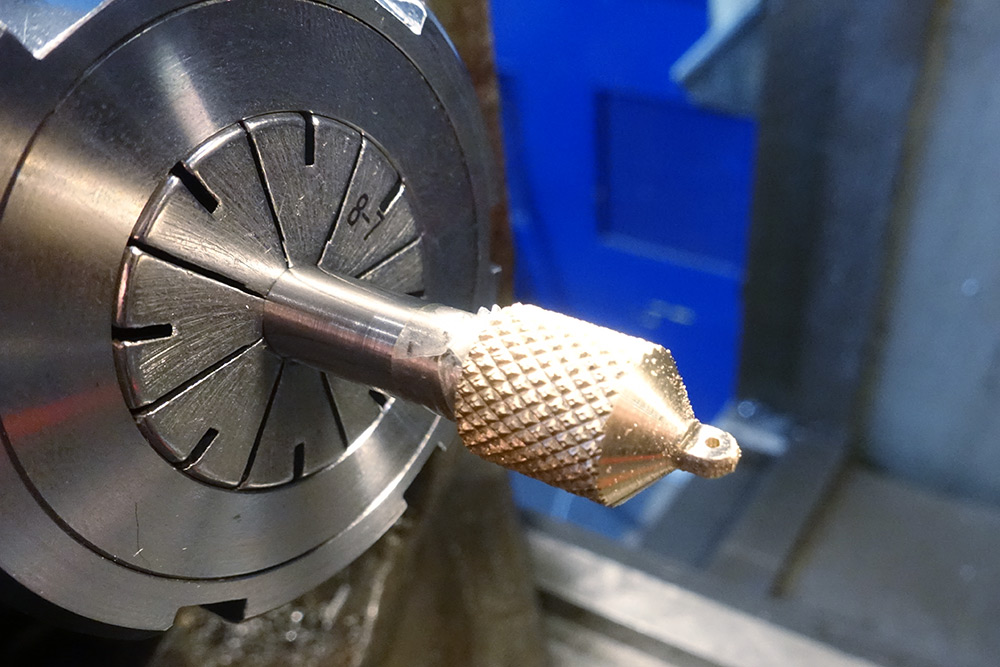 Holding a drill bit in the collet, with the brass part wedged onto it