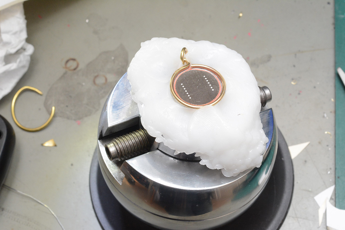 Necklace mounted to ball vice using polymoph plastic