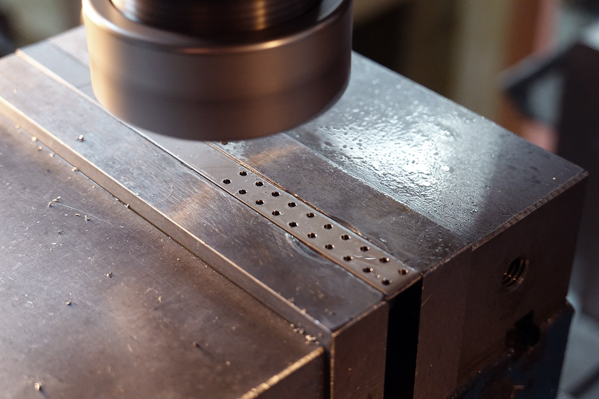 Holes in a strip of stainless