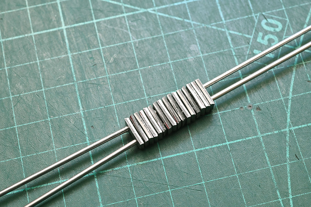 All the linkages threaded onto two filler rods