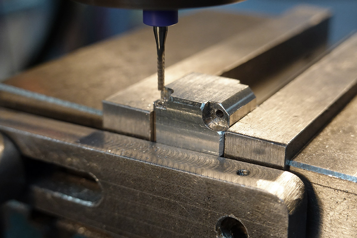 Using a 1.7mm endmill to widen and correct the position of the hinge hole