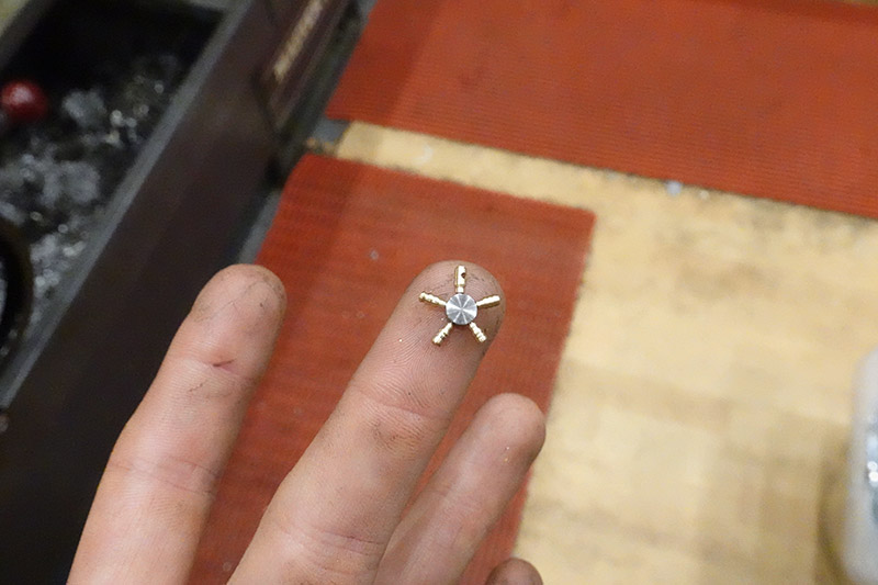 Test assembly of earring, held with one finger