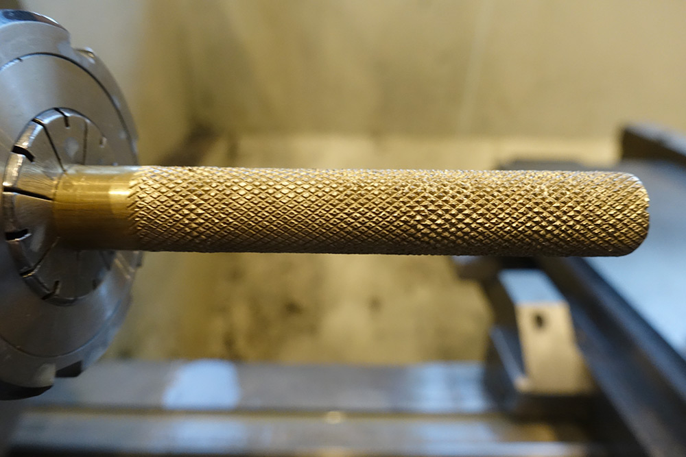 A long knurled brass rod