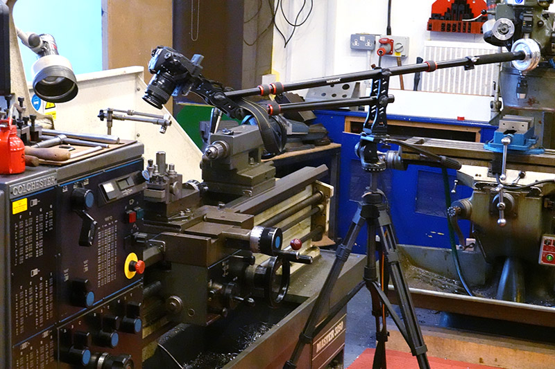 A DSLR camera with macro lens held on the end of a 2 metre jib, hanging over the colchester lathe