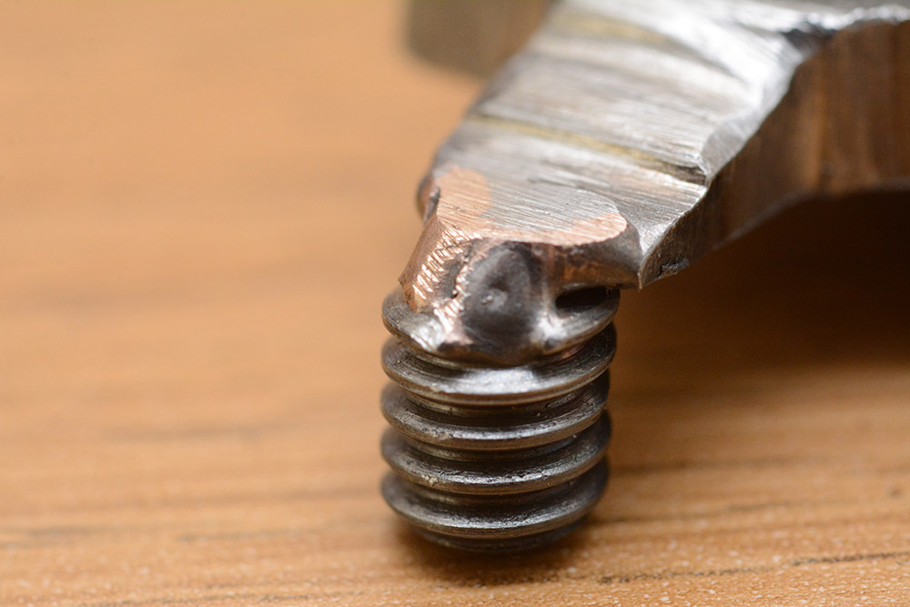 Extreme closeup of the brazing between the threaded portion and the main body of the tripod shifter. Part of the steel has melted.