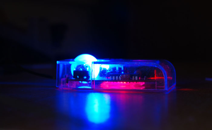 Finished transparent mouse, in the dark, with LEDs glowing