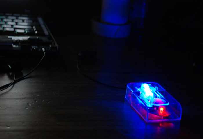 Finished transparent mouse, in the dark, with LEDs glowing