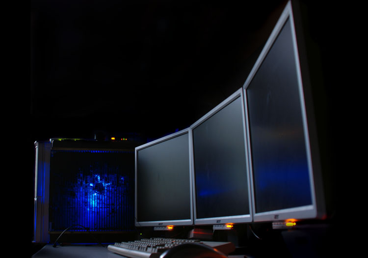 Stylish shot of the finished PC with monitors off, LEDs glowing