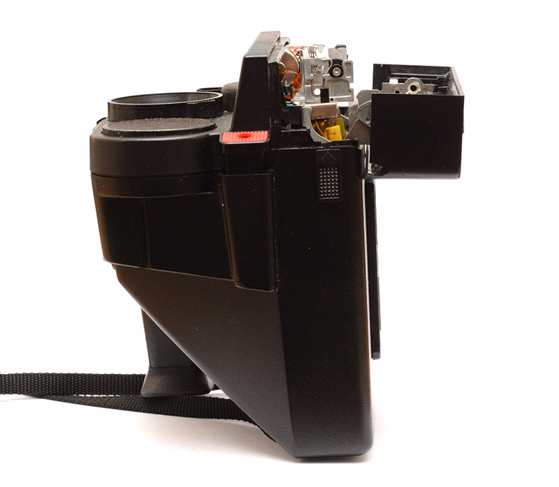 Side view of the completed camera on its back, with front panel open