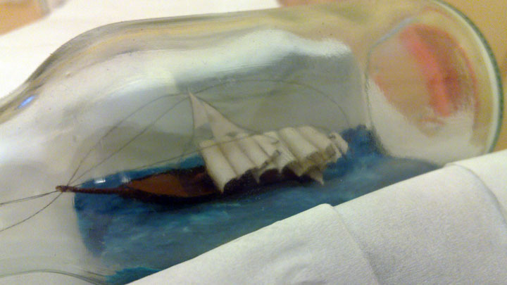 Ship in bottle with masts flattened