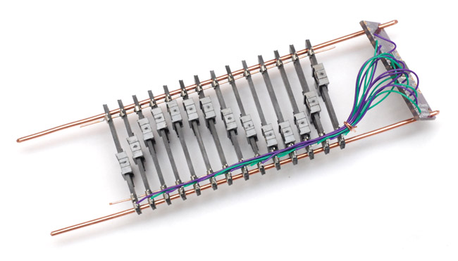 Assembling the linear potentiometers onto rails and wiring them up to the multiplexer