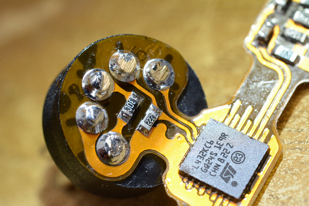 Closeup of the flexible circuit right after soldering, with flux cleaner still visible