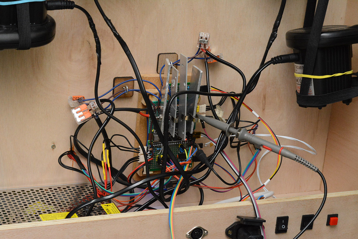 An oscilloscope probe monitors a signal on the circuit board