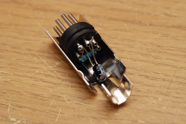 A resistor and capacitor soldered inside the DIN housing